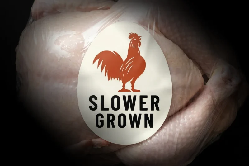 Slower grown chicken label with rooster logo on raw poultry