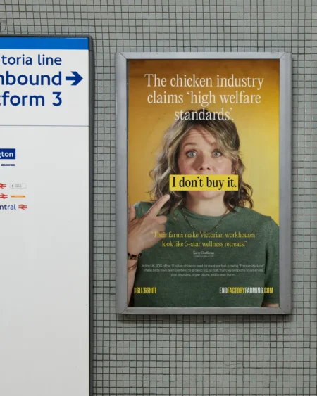 A campaign poster for End Factory Farming displayed in a London Underground station, featuring comedian Kerry Godliman and the text "I don't buy it."