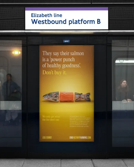 An End Factory Farming campaign poster on the Elizabeth line, showing a salmon split into three pieces with the text "Don't buy it."